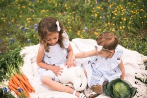 Photo of girls with bunny in flowers